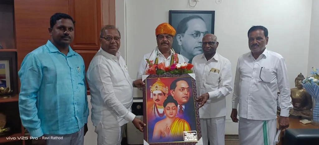 Shri L G Gupta President P E Society Bhalki felicitating Shri Radha Krishna Sir on a goodwill meet at his residence in Banglore.